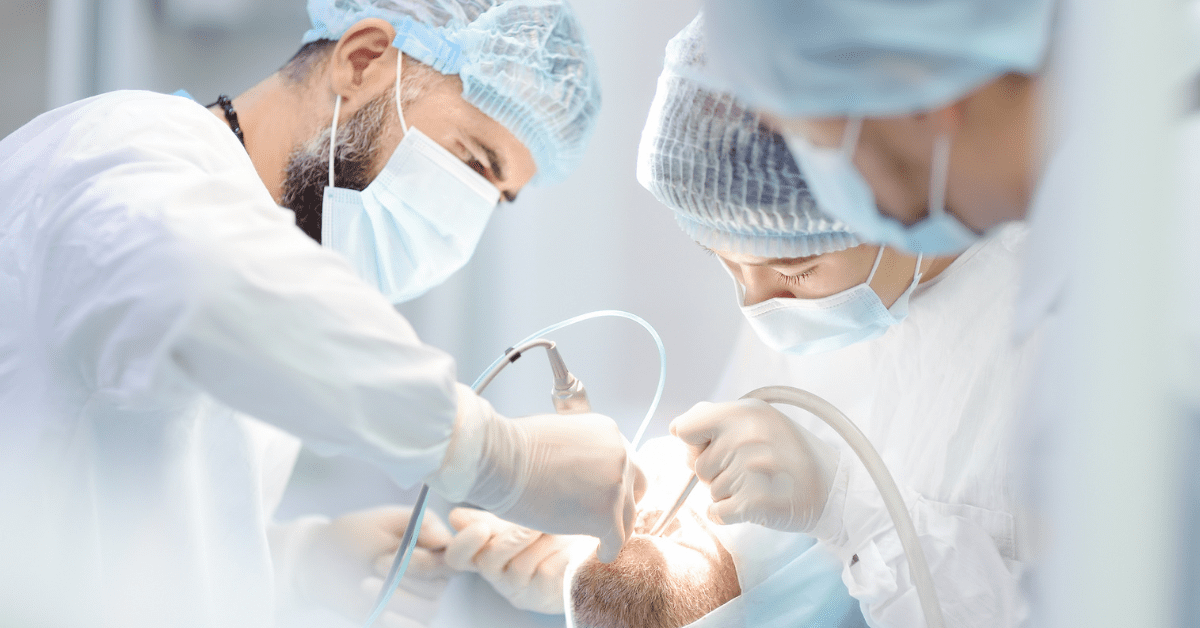 **Short alt text:** Dentists performing sedation dentistry procedure