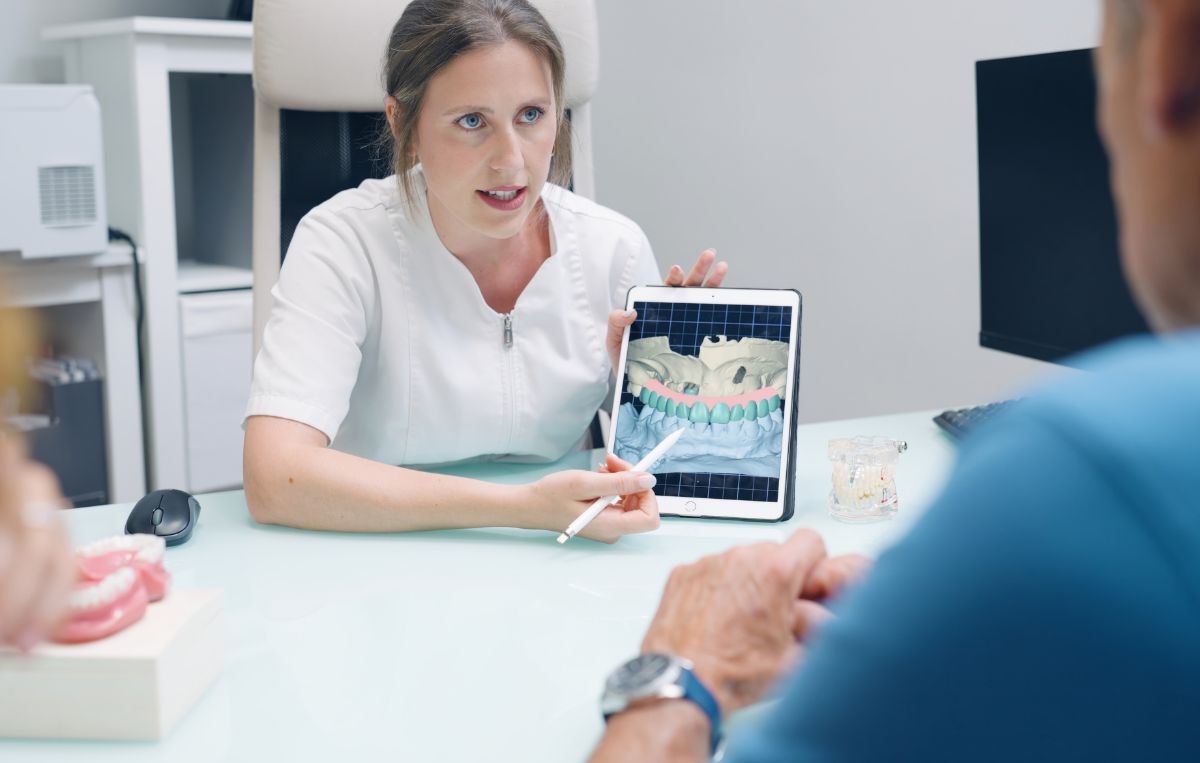 Dentist explaining dental implant treatment using a digital model at Sunnyvale Implant Center in San Jose, CA