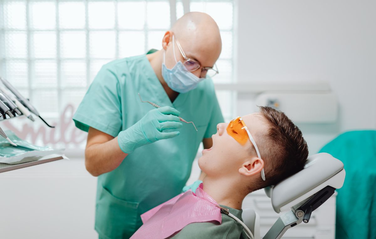 Dentist performing dental exam on patient at Sunnyvale Implant Center in San Jose, CA